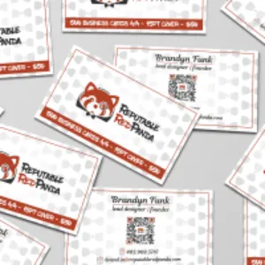 Several business cards featuring a red panda logo are scattered across a textured surface
